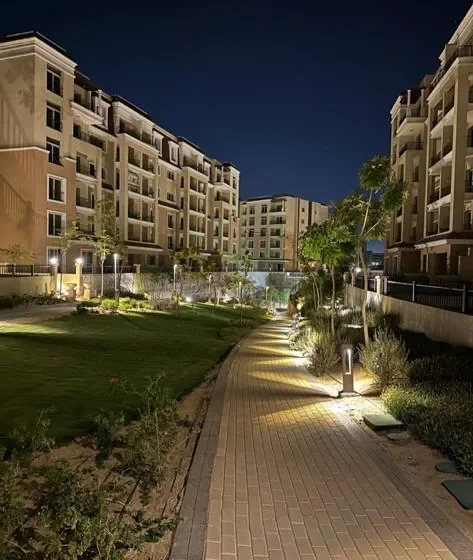 Illuminated landscaped walkway at Sarai