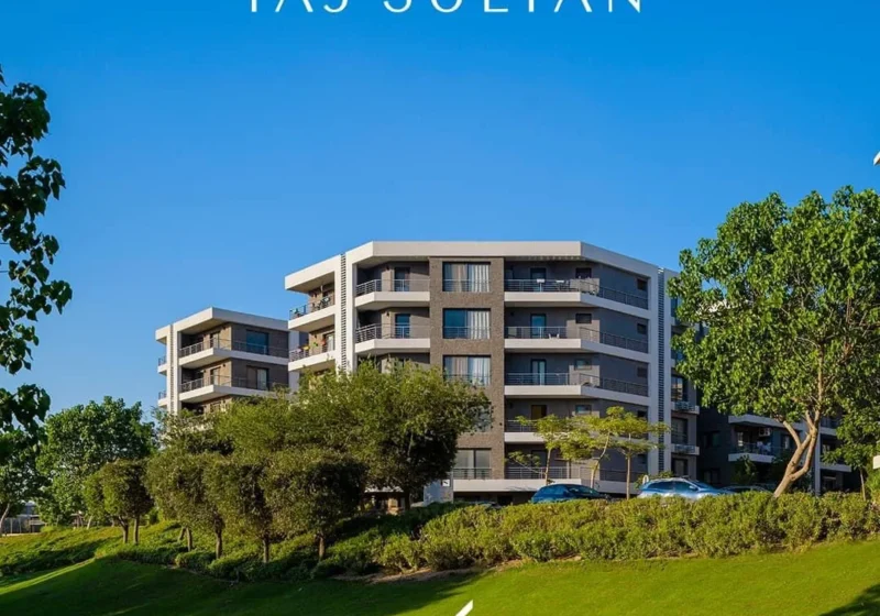 Completed apartment building surrounded by greenery at Taj City